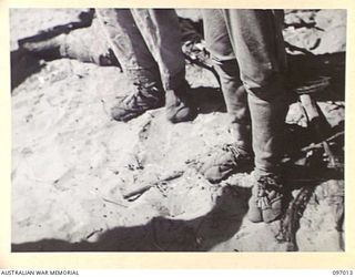 THE MAKESHIFT FOOTWEAR WORN BY JAPANESE TROOPS OF THE NUMA NUMA GARRISON FORCE. MEMBERS OF THE AUSTRALIAN SURRENDER PARTY FROM HEADQUARTERS 2 CORPS HAVE ARRIVED AQT NUMA NUMA PLANTATION TO DISCUSS ..