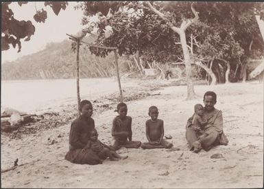 A family on the beach at Longapollo, Solomon Islands, 1906 / J.W. Beattie