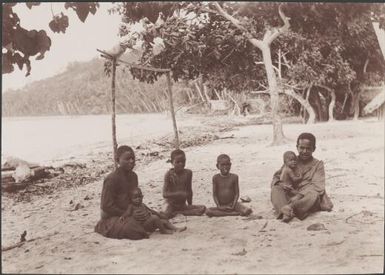 A family on the beach at Longapollo, Solomon Islands, 1906 / J.W. Beattie