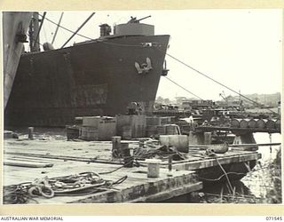 LAE, NEW GUINEA. 1944-03-23. THE LAE WATERSIDE SCENE AT HEADQUARTERS, LAE BASE SUB-AREA FROM THE END OF NO 2 LIBERTY WHARF, A PONTOON WHARF HANDLING SMALL SHIPS. THE OLD JETTY IN THE RIGHT CENTRE ..