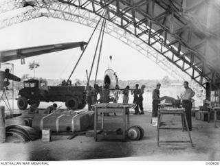 KIRIWINA, TROBRIAND ISLANDS, PAPUA. 1944-01-31. INSIDE THE HANGAR OF NO. 12 REPAIR AND SALVAGE UNIT RAAF, BEHIND THE BATTLE LINE, WHERE A SPITFIRE AIRCRAFT OF NO. 79 SQUADRON RAAF IS BEING REPAIRED