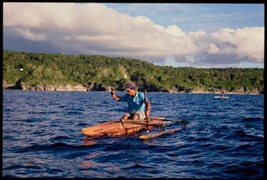 Man in an outrigger canoe, Niue