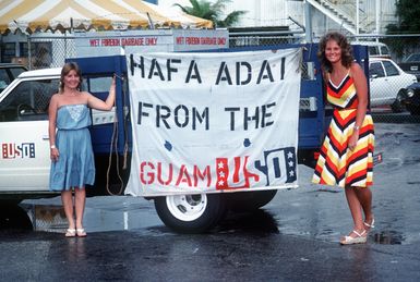 A USO sign at Naval Station Guam welcomes the crewmen of the combat stores ship USS NIAGARA FALLS (AFS 3) into port