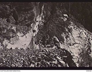 BULLDOG-WAU ROAD, NEW GUINEA, 1943-07-15. HUGE CUTTING THROUGH A LARGE ROCKY OUTCROP AT THE 27 MILE POINT