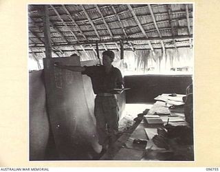KARAWOP, NEW GUINEA, 1945-09-18. SGT N. MCDONALD, ONE OF MANY INSTRUCTORS AT 2/6 CAVALRY COMMANDO REGIMENT'S EDUCATION SECTION, TAKING ONE OF HIS DAILY CLASSES