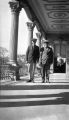 Two men standing in the outdoor hallway of the 'Iolani Palace, Honolulu, Hawaii, probably between 1920 and 1930