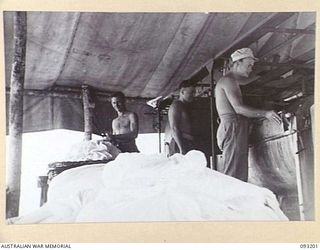 BOUGAINVILLE, 1945-06-18. PERSONNEL WORKING IN THE HOSPITAL LAUNDRY, 109 CASUALTY CLEARING STATION, MOTUPENA POINT. IDENTIFIED PERSONNEL ARE:- L-CPL R. CARTER (1); L-CPL R.V. PRICE (2); PTE R.J. ..