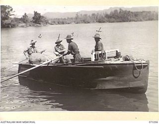 ALEXISHAFEN, NEW GUINEA. 1944-05-15. AN OLD BOAT RETRIEVED FROM THE SEA BED AT ALEXISHAFEN, IS NOW USED BY MEMBERS OF THE 2/15TH FIELD AMBULANCE TO TRANSPORT MAIL AND PASSENGERS TO VARIOUS UNITS. ..