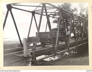 BOUGAINVILLE. 1945-05-30. A 3-TON VEHICLE CARRYING SUPPLIES TO FORWARD TROOPS CROSSING THE GILES BRIDGE. THE BRIDGE, A GENERAL STEEL TYPE WAS NAMED AFTER LIEUTENANT L. GILES, 5 FIELD COMPANY ROYAL ..