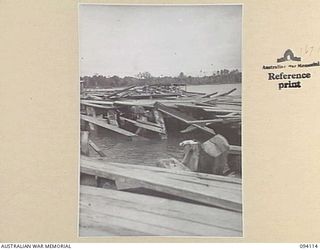 BUNA, NEW GUINEA, 1945-07-03 TO 1945-07-04. THE RUINS OF THE DOCKS AT BUNA BEACH