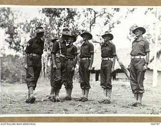 POM POM VALLEY, NEW GUINEA. 1943-11-27. SX12030 LEITUENANT E. C. S. MELDRUM, GUARD OFFICER, INSPECTING MEMBERS OF THE 2/10TH AUSTRALIAN INFANTRY BATTALION GUARD, THE CHAMPION GUARD UNIT OF THE 18TH ..