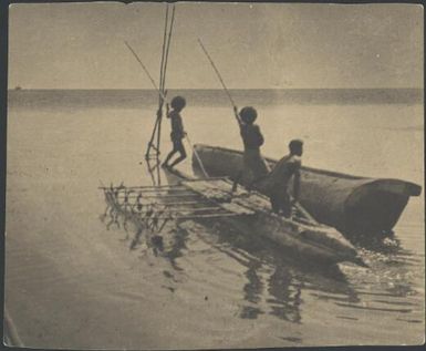 Three men in an outrigger canoe levering a lakatoi hull, Motuan, Port Moresby, Papua, ca. 1923 / Sarah Chinnery