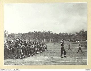 POM POM VALLEY, NEW GUINEA, 1944-02-16. OFFICERS AND MEN OF 2/27TH INFANTRY BATTALION, 21ST INFANTRY BRIGADE MARCHING PAST THE SALUTING BASE IN THEIR FAREWELL PARADE AT WHICH LIEUTENANT-GENERAL SIR ..