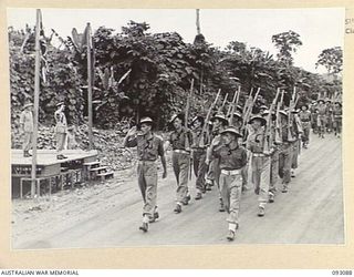 LAE AREA, NEW GUINEA, 1945-06-16. LT-GEN V.A.H. STURDEE, GOC FIRST ARMY (1), TAKING THE SALUTE, DURING A PARADE, ATTENDED BY ALL ENGINEER COMPANIES UNDER THE COMMAND OF 11 COMMANDER, ROYAL ..