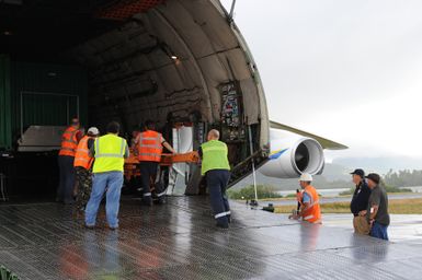 Earthquake ^ Flooding ^ Tsunami - Pago Pago, American Samoa, October 13, 2009 -- Mark Ackerman (in navy blue shirt), Federal Emergency Management Agency Staging Area Manager, oversees the unloading of generators from the Antonov AN-225 cargo plane. The cargo plane is the largest in the world and carried generators contracted by the Federal Emergency Management Agency to assist the island with electrical power restoration. David Gonzalez/FEMA