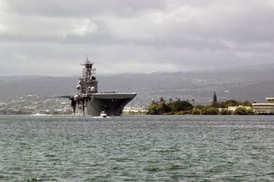 A bow on view showing the US Navy (USN) USS Wasp Class Amphibious Assault Ship USS BONHOMME RICHARD (LHD 6) underway exiting the harbor at Navy Base (NB) Pearl Harbor, Hawaii (HI) for the start of the Rim of the Pacific (RIMPAC) 2006 Exercises. A harbor patrol craft is visible in the foreground. RIMPAC is the largest biennial maritime exercise, which brings together military forces from Australia, Canada, Chile, Peru, Japan, the Republic of Korea, the United Kingdom and the US