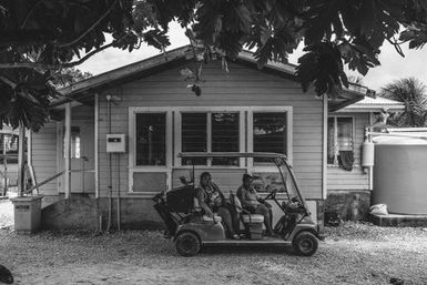 Locals in golf cart, Fakaofo, Tokelau