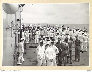 AT SEA OFF RABAUL, NEW BRITAIN. 1945-09-06. NAVAL RATINGS WAITING TO FALL IN FOR THE PARADE AT THE SURRENDER CEREMONY COVERING THE SURRENDER OF ALL JAPANESE FORCES IN NEW GUINEA, NEW BRITAIN AND ..