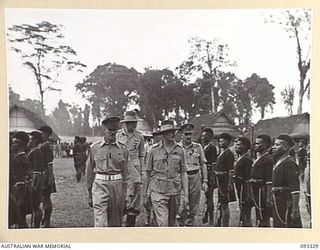 LAE AREA, NEW GUINEA, 1945-06-28. HIS ROYAL HIGHNESS, THE DUKE OF GLOUCESTER, GOVERNOR-GENERAL OF AUSTRALIA (2) AND SENIOR OFFICERS INSPECTING ROYAL PAPUAN CONSTABULARY TROOPS. THE GOVERNOR-GENERAL ..