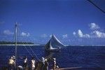 Samoan boats and natives in Pago Pago harbor as photographed by a member of the Capricorn Expedition (1952-1953) during a stopover in American Samoa. 1953