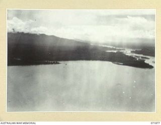 LAE, NEW GUINEA. 1944-03-30. AN AERIAL VIEW OF THE MARKHAM RIVER ENTERING THE SAE AT LAE