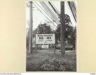 TOROKINA, BOUGAINVILLE ISLAND. 1945-01-18. THE NOTICE BOARD OUTSIDE THE PACIFIC EXCHANGE. THIS EXCHANGE WAS ORIGINALLY INSTALLED BY AN AMERICAN SIGNALS UNIT AND THEN WAS TAKEN OVER BY "B" CORPS OF ..