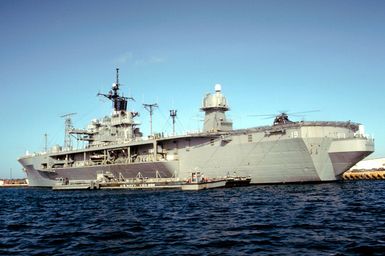 A fuel barge is anchored alongside the amphibious command ship USS BLUE RIDGE (LCC-19) during the Blue Ridge's port visit