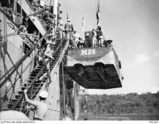 SIMPSON HARBOUR, RABAUL, NEW BRITAIN. 1945-09-10. BARGE BEING LOWERED FROM HMAS MANOORA IN SIMPSON HARBOUR, PREPARATORY TO LANDING TROOPS OF 4 INFANTRY BRIGADE. THE TROOPS WILL OCCUPY THE RABAUL ..