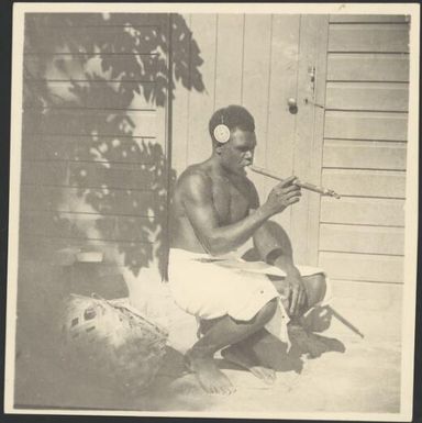 Asavia [?] smoking a traditional bamboo pipe, Rabaul, New Guinea, ca. 1936 / Sarah Chinnery