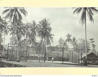 LAE, NEW GUINEA. 1944-07-09. PERSONNEL ENJOYING A GAME ON THE TENNIS COURTS AT HEADQUARTERS, AUSTRALIAN NEW GUINEA ADMINISTRATIVE UNIT