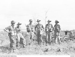 WEWAK POINT, NEW GUINEA, 1945-05-12. LT-COL G.S. COX, COMMANDING OFFICER 2/4 INFANTRY BATTALION (4), WITH LT-COL R.F. JABOOR, 2/2 FIELD REGIMENT, ROYAL AUSTRALIAN ARTILLERY (2), AND SOME OF HIS ..