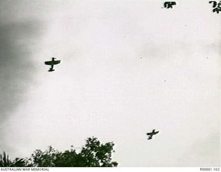 THE SOLOMON ISLANDS, 1945-04-24/27. TWO RNZAF CORSAIR AIRCRAFT FLYING OVER THE JUNGLE ON BOUGAINVILLE ISLAND. (RNZAF OFFICIAL PHOTOGRAPH.)