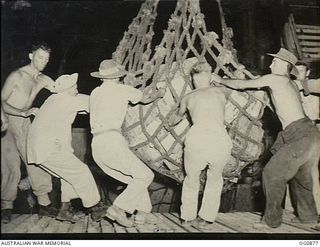 KIRIWINA, TROBRIAND ISLANDS, PAPUA. 1943-11-27. AIRMEN WORKING THROUGH THE NIGHT TO UNLOAD CARGO FOLLOWING THE MOVE OF NOS. 22 AND 30 SQUADRONS RAAF FROM GOODENOUGH TO KIRIWINA ON BOARD SS HANYANG. ..