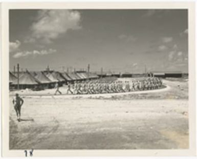 [Servicemen marching in formation at military camp, Saipan]