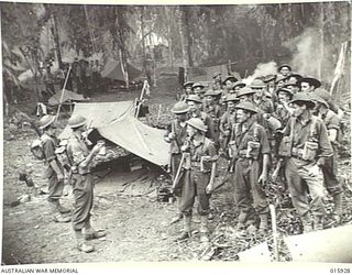1943-10-06. NEW GUINEA. ATTACK ON LAE. THIS PLATOON OF FAMOUS AUSTRALIAN BATTALION TOOK PART IN THE VICTORIOUS ADVANCE ON LAE. THEY INFLICTED HEAVY CASUALTIES ON THE JAP. LT. JACK SCOTT FROM ..