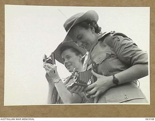 DONADABU, PAPUA, NEW GUINEA. 1944-01-01. NFX142589 SISTER R. REID (1) AND NFX142586 SISTER J. L. ALLAN (2); OF THE 2/9TH GENERAL HOSPITAL TAKING PHOTOGRAPHS DURING THE 15TH INFANTRY BRIGADE ..