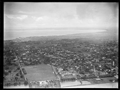 Suva Harbour and Albert Park with rugby fields and the Fijian Parliament Building with Suva beyond, Viti Levu, Fiji