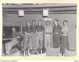 TOROKINA, BOUGAINVILLE. 1945-11-26. THE ANNOUNCING STAFF, IN THE AUDITORIUM OF RADIO STATION 9AC TOROKINA, AUSTRALIAN ARMY AMENITIES SERVICE BROADCASTING STATION ON BOUGAINVILLE. IDENTIFIED ..