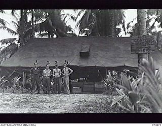 ALEXISHAFEN, NEW GUINEA. 1944-06-16. CANTEEN ISSUING POINT NO. 2, AUSTRALIAN ARMY CANTEENS SERVICE, AT HEADQUARTERS 8TH INFANTRY BRIGADE. THE UNIT IS LOCATED AT NORTH ALEXISHAFEN. LEFT TO RIGHT: ..