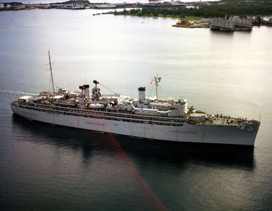 A starboard view of the repair ship USS JASON (AR 8) departing the harbor