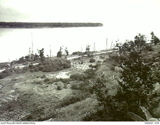 REMAINS OF A JAPANESE CAMP AND HALF-TRACKED VEHICLE ON THE COASTAL ROAD, NUSA PARADE. (RNZAF OFFICIAL PHOTOGRAPH.)