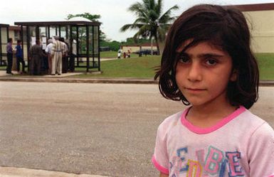 A Kurdish girl stands outside her temporary residence at Andersen Air Force Base, Guam, while being housed at the base as part of Operation PACIFIC HAVEN. The operation, a joint humanitarian effort conducted by the US military, entails the evacuation of over 2,100 Kurds from northern Iraq to avoid retaliation from Iraq for working with the US government and international humanitarian agencies. The Kurds will be housed at Andersen AFB, while they go through the immigration process for residence in the United States