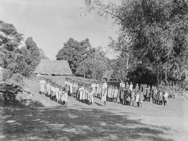 [Rows of Pacific Island children in front of a building]