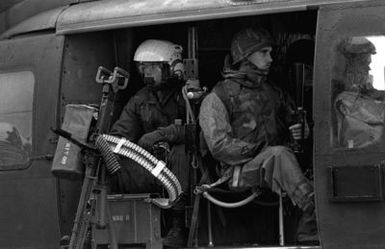 Crewmen aboard a UH-1 Iroquois helicopter prepare for takeoff from the flight deck of the amphibious assault ship USS GUAM (LPH 9), during operations off the coast of Beirut, Lebanon