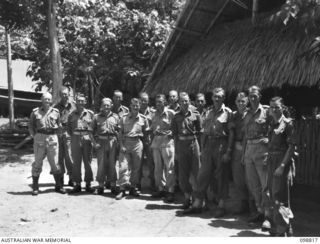 RATAVAL, NEW BRITAIN. 1945-11-17. OFFICERS OF 2/4 ARMOURED REGIMENT GROUPED OUTSIDE THEIR OFFICERS' MESS