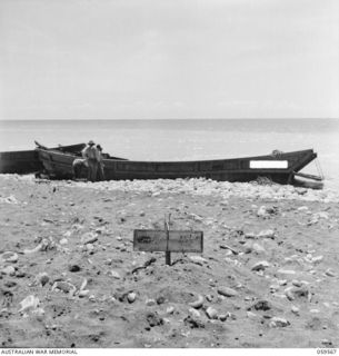 FINSCHHAFEN AREA, NEW GUINEA, 1943-10-23. 39 JAPANESE WERE KILLED IN THE INITIAL LANDING ON SCARLET BEACH. IN THE FOREGROUND CAN BE SEEN A MASS GRAVE CONTAINING FIVE OF THE DEAD SOLDIERS, WHILE IN ..