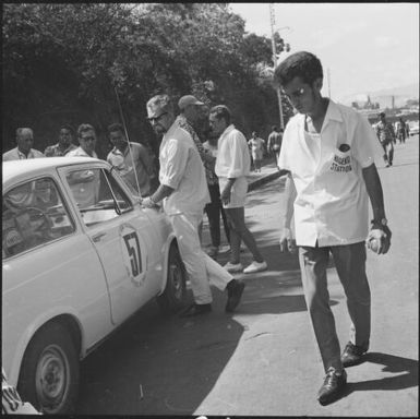 Spectators and crew observing a rally car during the 1st Safari Calédonien racing event, New Caledonia, 1967, 1 / Michael Terry