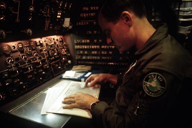 MASTER SGT. Kurt Knowles, a flight engineer with the 6th Air Refueling Squadron, 22nd Air Refueling Wing, performs a preflight inspection in the cockpit of a KC-10A Extender aircraft