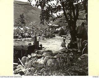 ZENAG, NEW GUINEA, 1944-02-27. A SPORTS CARNIVAL IN A CREEK DAMMED BY PERSONNEL OF THE 2/9TH FIELD COMPANY, ROYAL AUSTRALIAN ENGINEERS, GIVING 50 YARDS OF WATER, AND A DEPTH OF 6 FEET UNDER THE ..