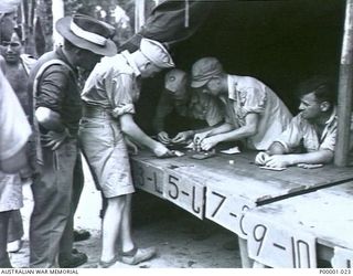 THE SOLOMON ISLANDS, 1945-01-12. WINNING PAYOUTS AT A COMBINED ANZAC SPORTS MEETING AT BOUGAINVILLE ISLAND. (RNZAF OFFICIAL PHOTOGRAPH.)